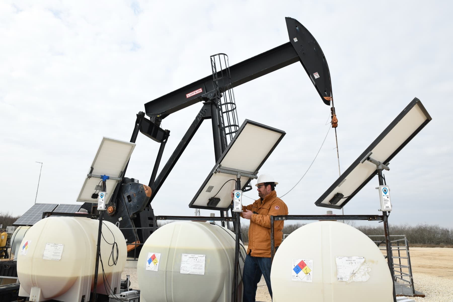 Three WellAware devices installed on chemical tanks in the field.