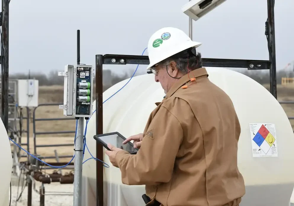 Image of a worker utilizing Wellaware and monitoring chemicals.